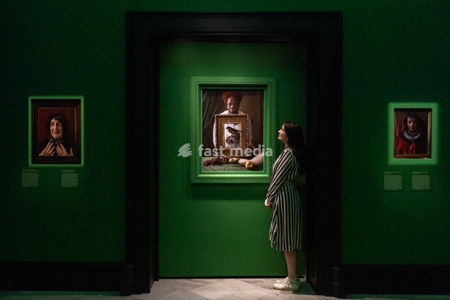 A staff member views (L-R) - 'Roz Kaveney, Headphones and Hen Feather', 'Olivette Cole-Wilson, and blackbird' and 'Kate Charlesworth, Ruby Brooch' all by Tim Walker as part of The National Portrait Gallery's 'Tim Walker's Fairyland: Love and Legends' Exhibition which runs from 9th October 2026 -…