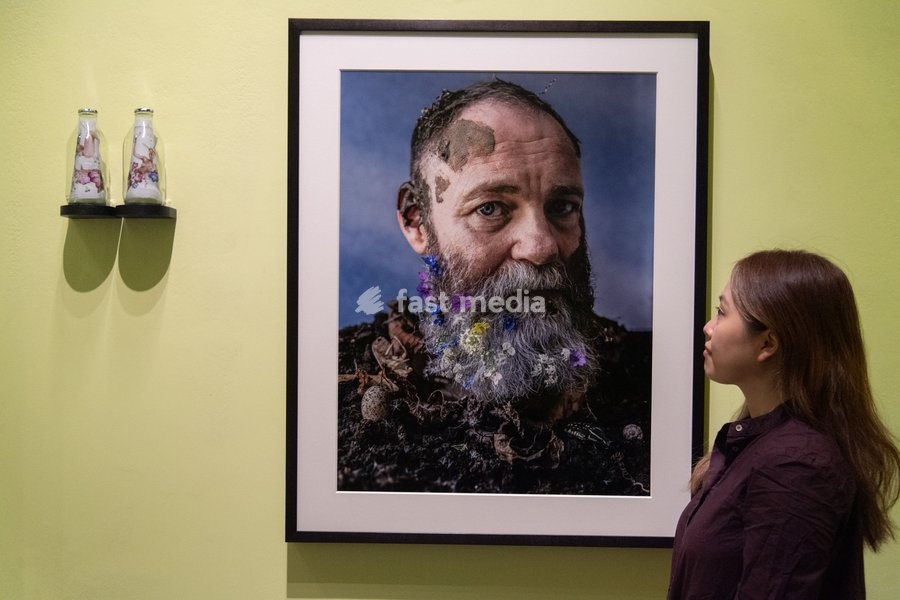 A staff member views 'Frances Lee, Ode to Edward Carpenter' by Tim Walker as part of The National Portrait Gallery's 'Tim Walker's Fairyland: Love and Legends' Exhibition which runs from 9th October 2026 - 7th February 2027 at National Portrait Gallery in London, England, UK on Wednesday 7 October,…
