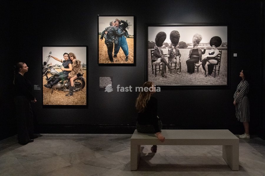 A staff member views (L-R) - 'Jane Campbell, Cherry Au and Lucy Edwards', 'Jane Campbell and Siobhan Fahey', 'Aphra and Jo Barwick, Siobhan Fahey and Emily Witham' all by Tim Walker as part of The National Portrait Gallery's 'Tim Walker's Fairyland: Love and Legends' Exhibition which runs from 9th…