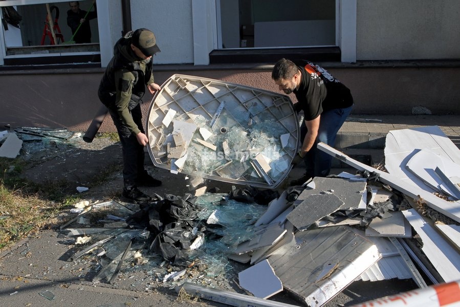Men work to eliminate the aftermath of a Russian missile strike near a damaged building, Dnipro, Ukraine, on October 6, 2026. Russian forces attacked Dnipro with missiles, damaging an industrial enterprise, apartment buildings, and a sports club