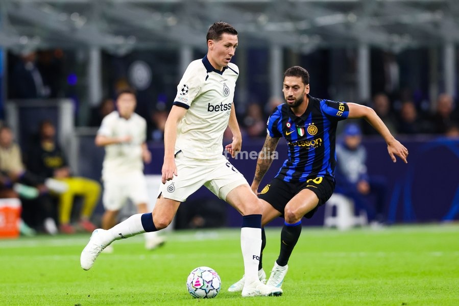Club's Hans Vanaken and Inter's Hakan Calhanoglu fight for the ball during a soccer game between Italian Inter Milan and Belgian Club Brugge KV, Tuesday 13 October 2026 in Milan, Italy, on day 2 of the UEFA Champions League league phase