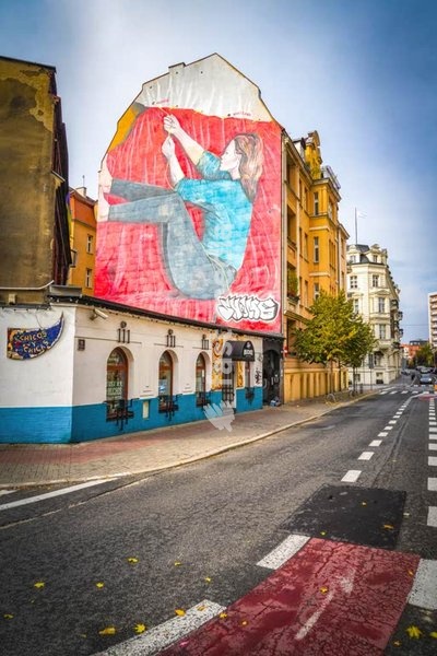 Women's solidarity mural, Poznań, Poland, woman pulling together Poland's cities on symbolic national flag artwork