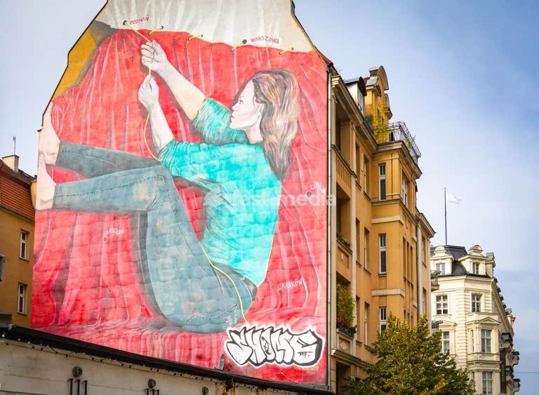 Women's solidarity mural, Poznań, Poland, woman pulling together Poland's cities on symbolic national flag artwork