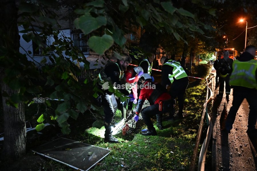 CAUTION, SENSITIVE CONTENT. Medics and law enforcement officers stand near the covered body of a person killed in a Russian missile strike on a nine-story residential building in Kyiv’s Desnianskyi district, Ukraine, on October 14, 2026. Russia launched a massive ballistic missile attack on the…