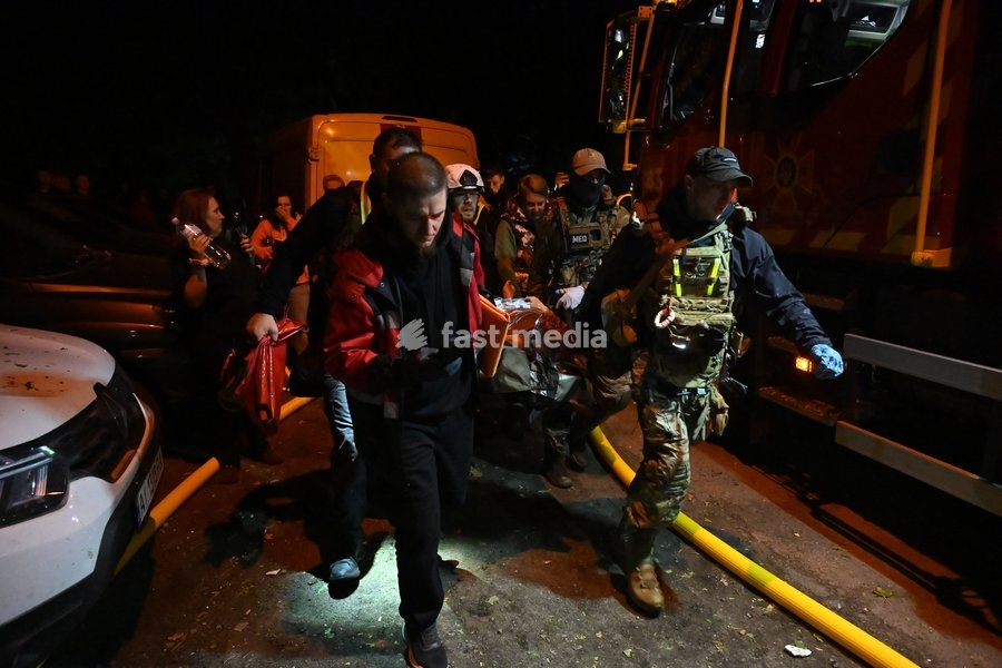 Rescuers carry a person injured in a Russian missile strike on a nine-story residential building in Kyiv’s Desnianskyi district, Ukraine, on October 14, 2026. Russia launched a massive ballistic missile attack on the capital. Three women were killed and 19 people were injured in the Desnianskyi…