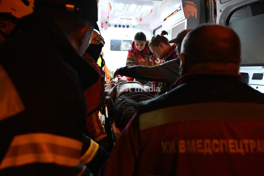 Medics provide assistance to a person injured in a Russian missile strike on a nine-story residential building in Kyiv’s Desnianskyi district, Ukraine, on October 14, 2026. Russia launched a massive ballistic missile attack on the capital. Three women were killed and 19 people were injured in the…