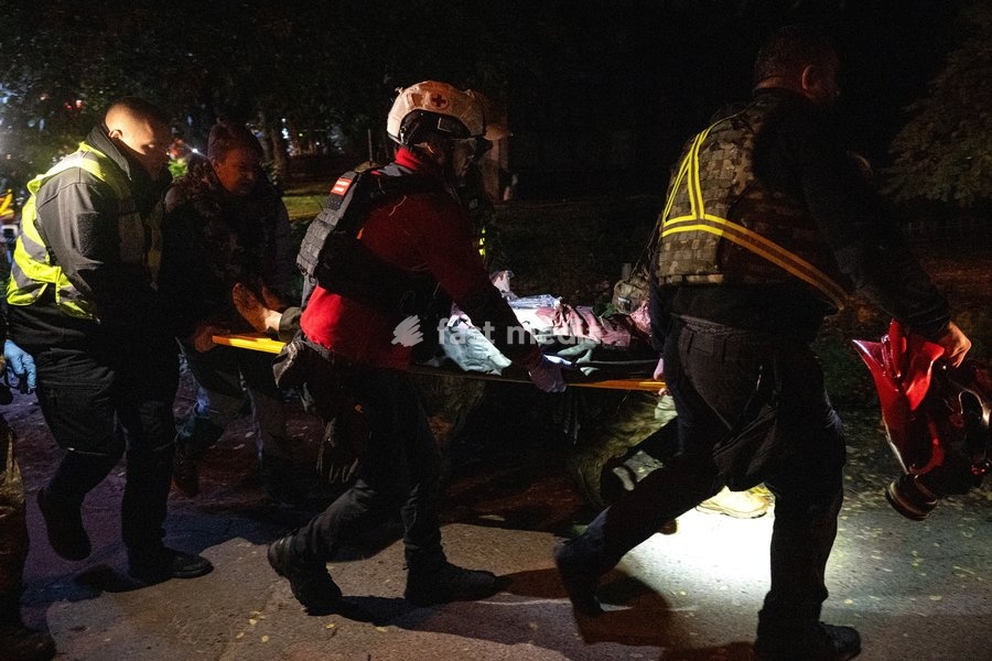 Rescuers carry an injured person on a stretcher after a Russian missile strike on a nine-story residential building in the Desnianskyi district of Kyiv, Ukraine, on October 14, 2026. Russia launched a massive ballistic missile attack on the capital. Three women were killed and 19 people were…