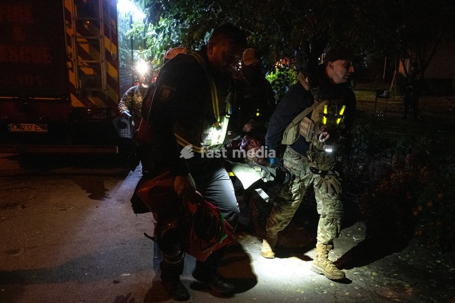 Rescuers carry on a stretcher a person injured in a Russian missile strike on a nine-story residential building in Kyiv’s Desnianskyi district, Ukraine, on October 14, 2026. Russia launched a massive ballistic missile attack on the capital. Three women were killed and 19 people were injured in the…