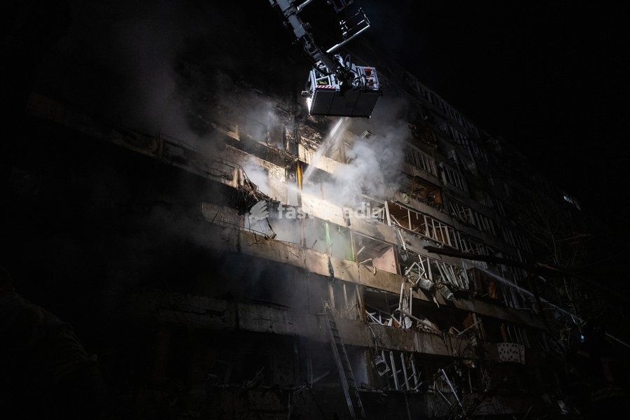 A rescuer on an aerial platform extinguishes a fire that broke out after a Russian missile strike on a nine-story residential building in Kyiv’s Desnianskyi district, Ukraine, on October 14, 2026. Russia launched a massive ballistic missile attack on the capital. Three women were killed and 19…