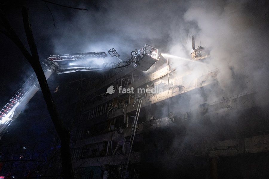 A rescuer on an aerial platform extinguishes a fire that broke out following a Russian missile strike on a nine-story residential building in Kyiv’s Desnianskyi district, Ukraine, on October 14, 2026. Russia launched a massive ballistic missile attack on the capital. Three women were killed and 19…