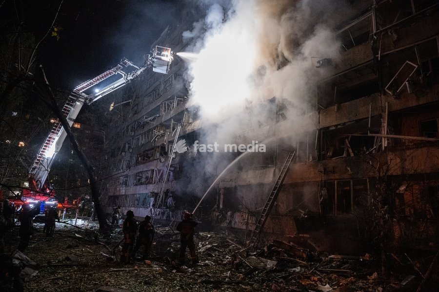 A rescuer on an aerial platform extinguishes a fire that broke out following a Russian missile strike on a nine-story residential building in Kyiv’s Desnianskyi district, Ukraine, on October 14, 2026. Russia launched a massive ballistic missile attack on the capital. Three women were killed and 19…