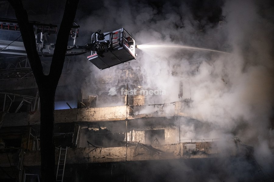 A rescuer on an aerial platform extinguishes a fire that broke out following a Russian missile strike on a nine-story residential building in Kyiv’s Desnianskyi district, Ukraine, on October 14, 2026. Russia launched a massive ballistic missile attack on the capital. Three women were killed and 19…