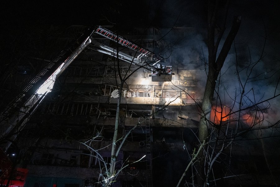 A rescuer on an aerial platform extinguishes a fire that broke out following a Russian missile strike on a nine-story residential building in Kyiv’s Desnianskyi district, Ukraine, on October 14, 2026. Russia launched a massive ballistic missile attack on the capital. Three women were killed and 19…