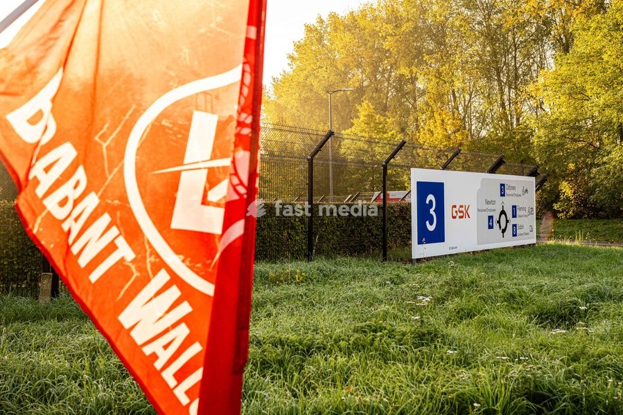 Union flags are seen at an entry gate as a GSK Belgium extraordinary works council is taking place in GSK Vaccine site in Wavre, on Wednesday 14 October 2026. The British pharmaceutical company GSK is one of the major employers in Wallonia, with sites in Wavre and Rixensart in Walloon Brabant, and…