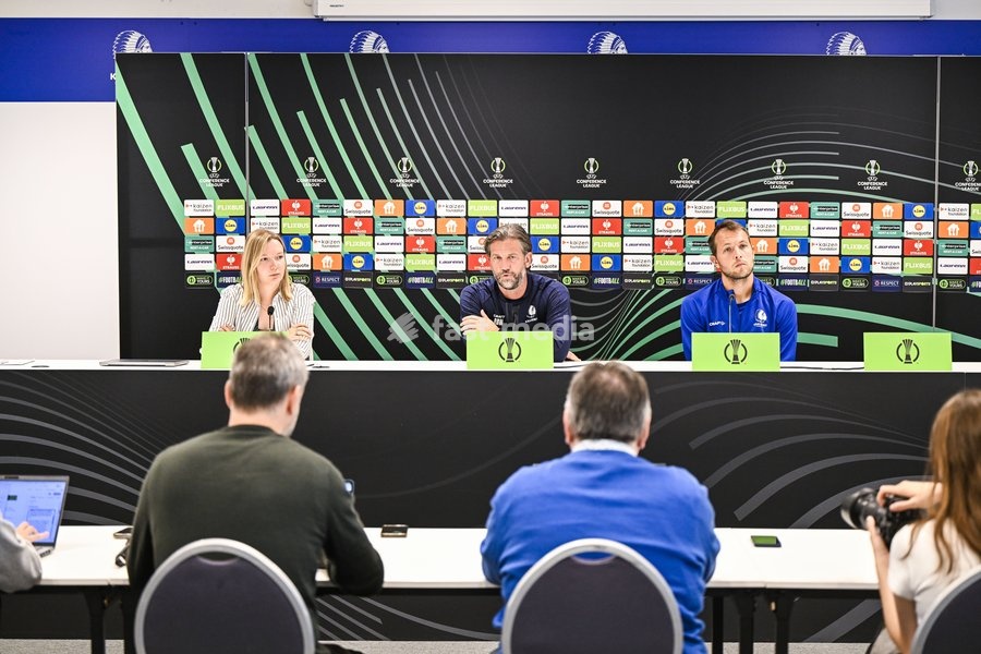 Gent's communications manager Tahnee Leece; Gent's head coach Rik De Mil and Gent's goalkeeper Davy Roef pictured during a press conference of Belgian soccer team KAA Gent, Wednesday 14 October 2026 in Gent. The team is preparing for the opening match of the UEFA Conference League league phase…