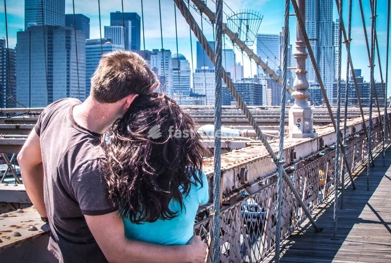 Young couple on Brooklyn Bridge, New York