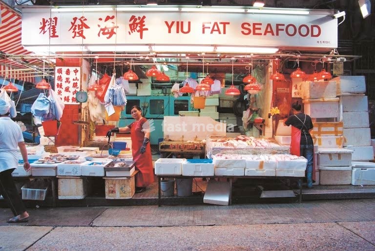 Yiu Fat Seafood market stall with vendors and fresh seafood, Hong Kong Island, China
