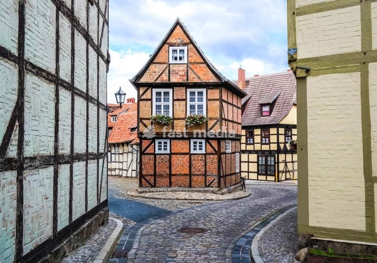 Medieval half-timbered houses line cobblestone street in historic Quedlinburg, Germany - UNESCO World Heritage Site with traditional architecture
