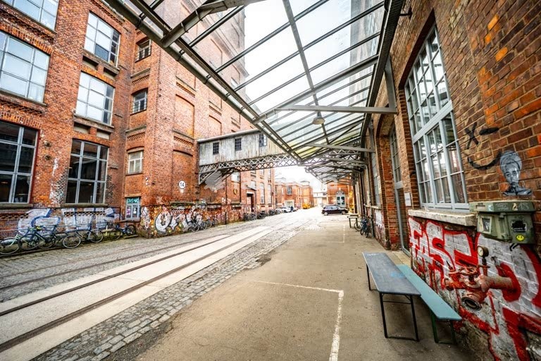 Leipzig Baumwollspinnerei industrial courtyard with rails and graffiti, artist studios in Plagwitz Germany