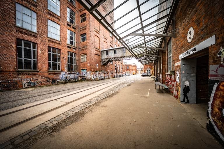 Leipzig Baumwollspinnerei industrial courtyard with rails and graffiti, artist studios in Plagwitz Germany