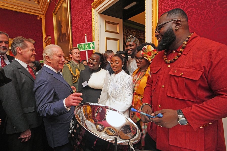 King Charles III watching Khan Cordice play the steel drums during a reception at St. James's Palace in London, to celebrate the Commonwealth Diaspora, ahead of the Commonwealth Heads of Government Meeting in Antigua and Barbuda. Picture date: Wednesday October 14, 2026