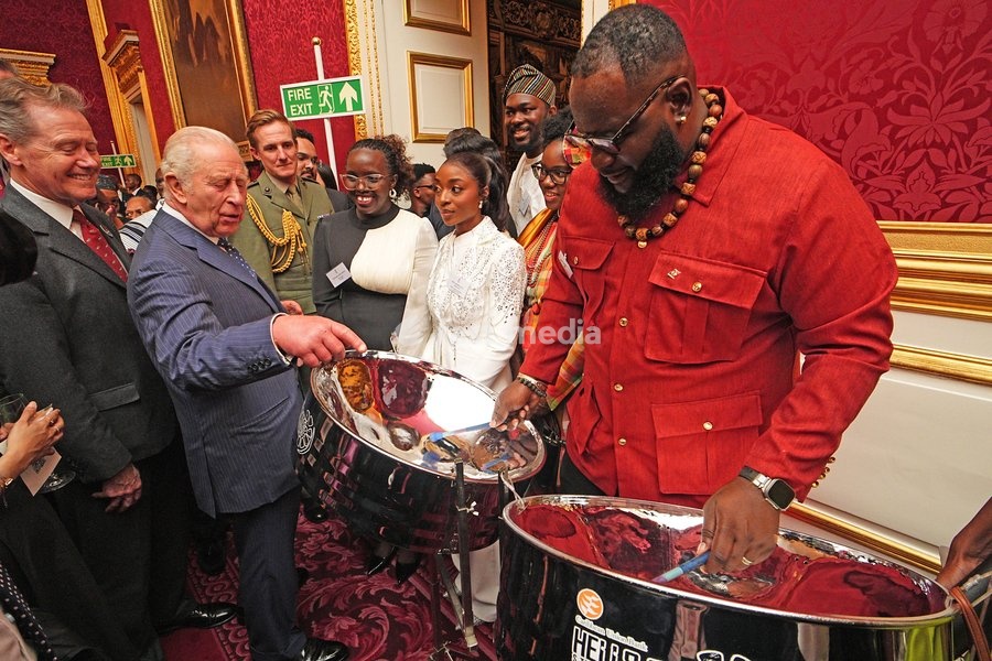 King Charles III watching Khan Cordice play the steel drums during a reception at St. James's Palace in London, to celebrate the Commonwealth Diaspora, ahead of the Commonwealth Heads of Government Meeting in Antigua and Barbuda. Picture date: Wednesday October 14, 2026