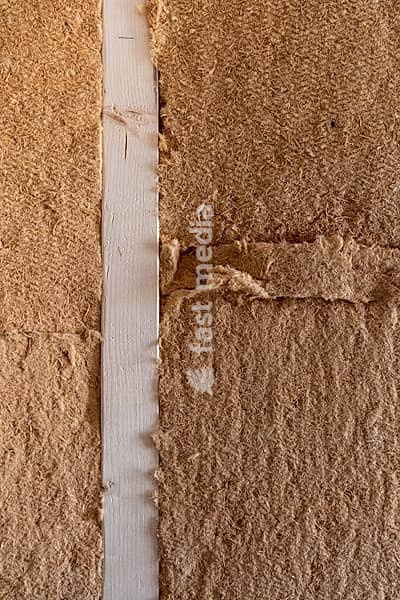 Close-up of rough brown wooden fiber insulation panels and light wooden strip, old building renovation, Stuttgart, Baden-Württemberg, Germany