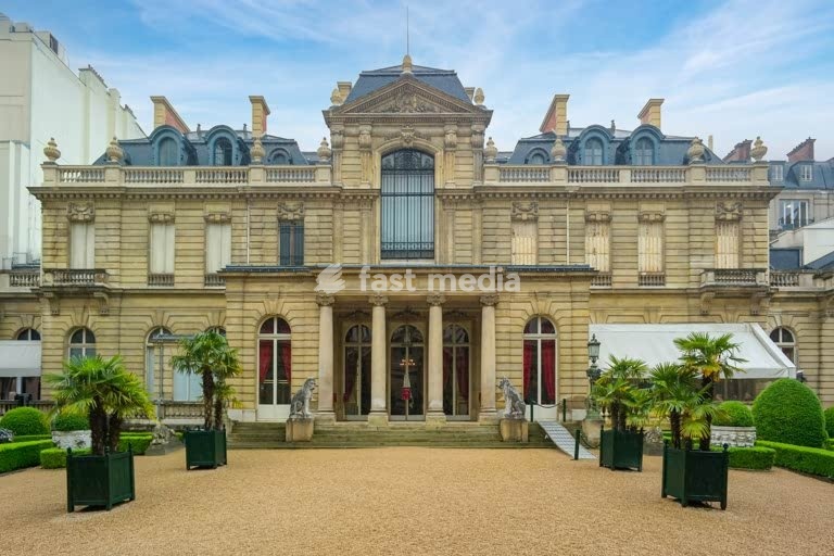Musée Jacquemart-André mansion facade with gravel courtyard and palms, Paris, France