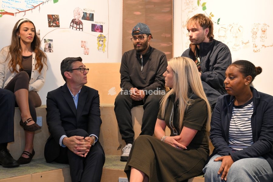 Britain's Prime Minister Andy Burnham sits next to cyclist Laura Kenny as he chats with young people during his visit of the King's Trust charity in Manchester, England, Thursday, Oct. 15, 2026