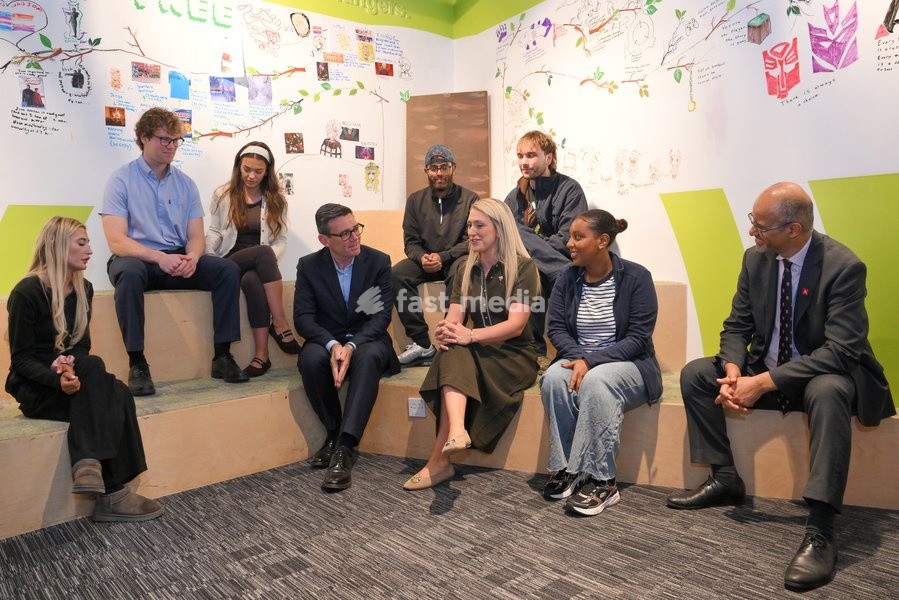 Britain's Prime Minister Andy Burnham sits next to cyclist Laura Kenny as he chats with young people during his visit of the King's Trust charity in Manchester, England, Thursday, Oct. 15, 2026