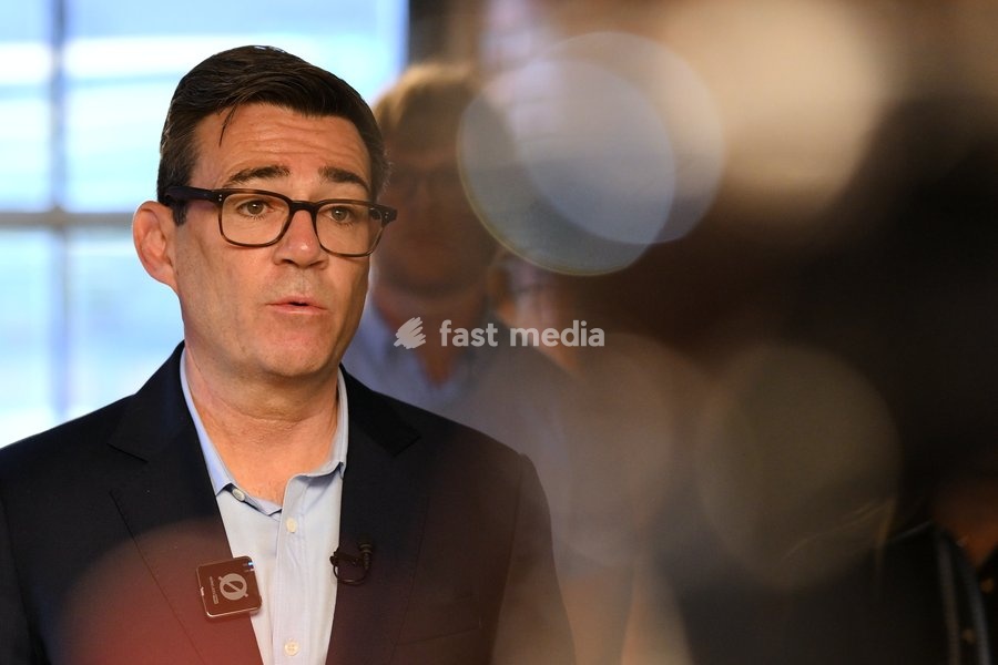 Britain's Prime Minister Andy Burnham speaks to employees during his visit of the King's Trust charity in Manchester, England, Thursday, Oct. 15, 2026