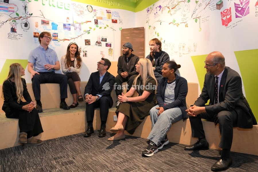 Britain's Prime Minister Andy Burnham sits next to cyclist Laura Kenny as he chats with young people during his visit of the King's Trust charity in Manchester, England, Thursday, Oct. 15, 2026