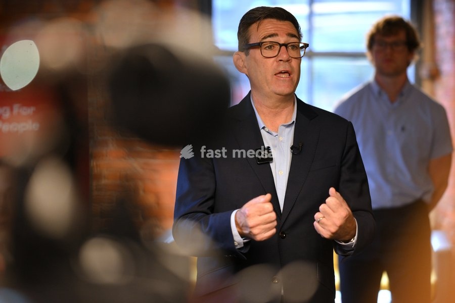 Britain's Prime Minister Andy Burnham speaks to employees during his visit of the King's Trust charity in Manchester, England, Thursday, Oct. 15, 2026