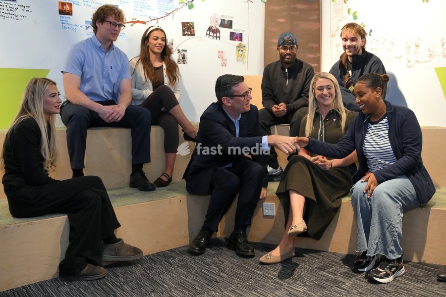 Britain's Prime Minister Andy Burnham sits next to cyclist Laura Kenny as he chats with young people during his visit of the King's Trust charity in Manchester, England, Thursday, Oct. 15, 2026