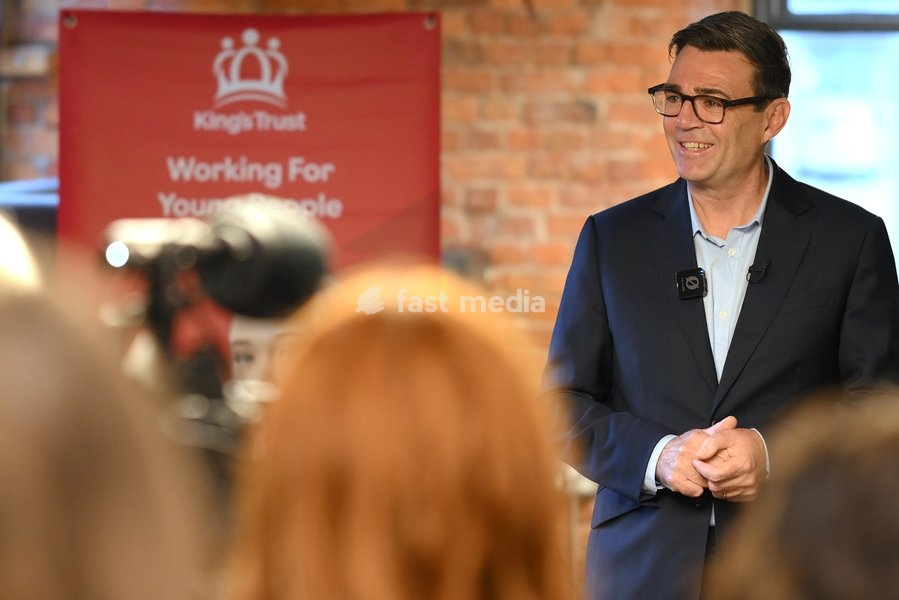 Britain's Prime Minister Andy Burnham speaks to members of staff during his visit of the King's Trust charity in Manchester, England, Thursday, Oct. 15, 2026