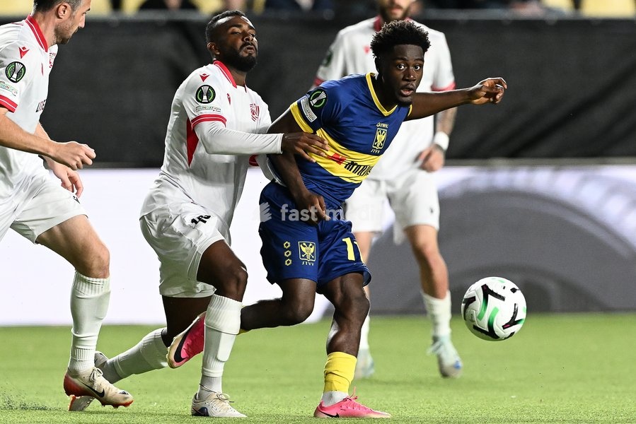 Iberia's Lucas Cafe and STVV's Nathanael Mbuku pictured in action during a soccer game between Belgian Sint-Truidense VV and Georgian FC Iberia 1999 Tbilisi, Thursday 15 October 2026 in Sint-Truiden, the opening match of the UEFA Conference League league phase