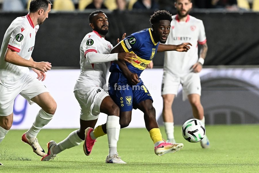 Iberia's Lucas Cafe and STVV's Nathanael Mbuku pictured in action during a soccer game between Belgian Sint-Truidense VV and Georgian FC Iberia 1999 Tbilisi, Thursday 15 October 2026 in Sint-Truiden, the opening match of the UEFA Conference League league phase
