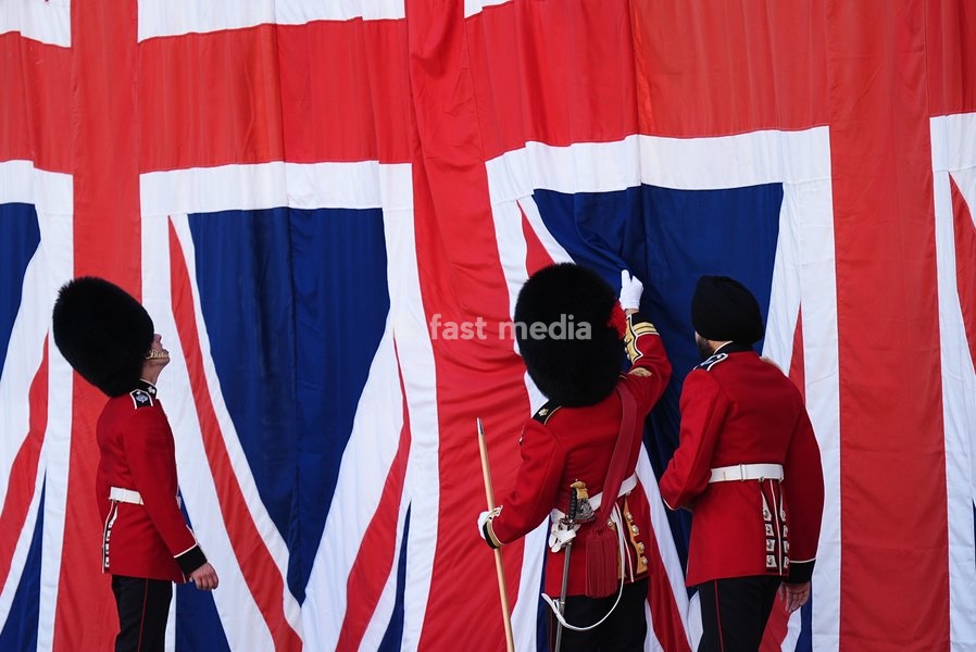 Members of the Household Division adjust a curtain ahead of the Household Cavalry's centenary dedication of the Guards Memorial, at Horse Guards Parade, central London. Picture date: Friday October 16, 2026