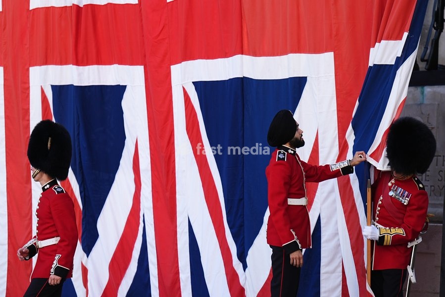 Members of the Household Division adjust a curtain ahead of the Household Cavalry's centenary dedication of the Guards Memorial, at Horse Guards Parade, central London. Picture date: Friday October 16, 2026