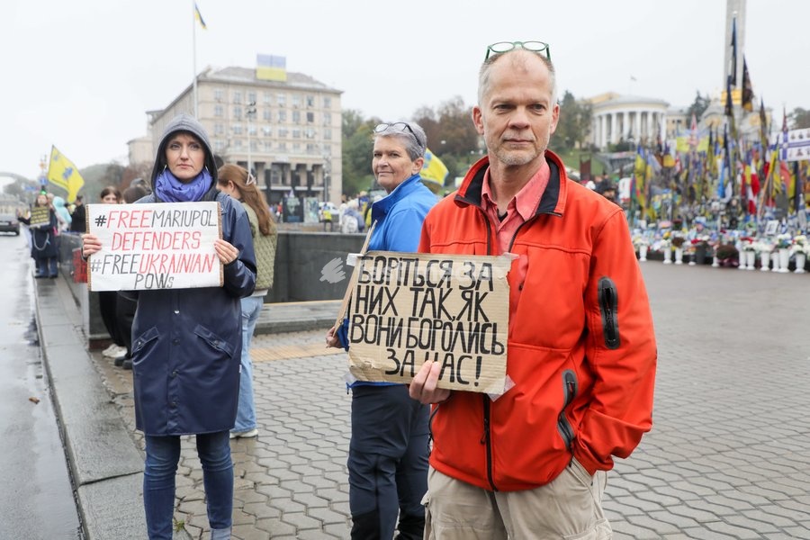 An activist holds a placard reading "Fight for Them Just as They Fought for Us!" during the weekly “Don’t Stay Silent! Captivity Kills” rally in support of Ukrainian military personnel held in Russian captivity or listed as missing in action in Maidan Nezalezhnosti (Independence Square), Kyiv,…
