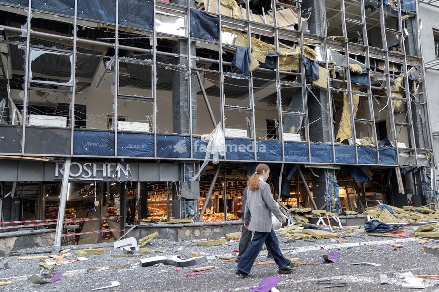 People walk past a confectionery shop on the ground floor of a shopping mall in the Solomianskyi district is damaged by a Russian attack, Kyiv, Ukraine, October 19, 2026. During the night and morning, Russia launched a massive strike on the capital using ballistic missiles, cruise missiles, and…