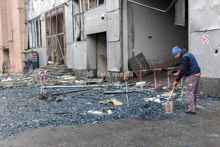 A man shovel away glass shards outside a building in the Solomianskyi district damaged by a Russian attack, Kyiv, Ukraine, October 19, 2026. During the night and morning, Russia launched a massive strike on the capital using ballistic missiles, cruise missiles, and drones. According to Kyiv city…