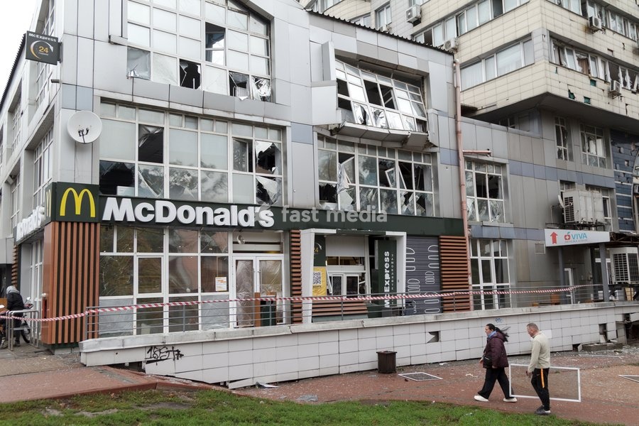 A man and a woman walk past a fast food restaurant in the Solomianskyi district damaged by a Russian attack, Kyiv, Ukraine, October 19, 2026. During the night and morning, Russia launched a massive strike on the capital using ballistic missiles, cruise missiles, and drones. According to Kyiv city…