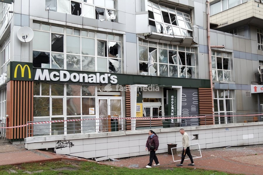 A man and a woman walk past a fast food restaurant in the Solomianskyi district damaged by a Russian attack, Kyiv, Ukraine, October 19, 2026. During the night and morning, Russia launched a massive strike on the capital using ballistic missiles, cruise missiles, and drones. According to Kyiv city…