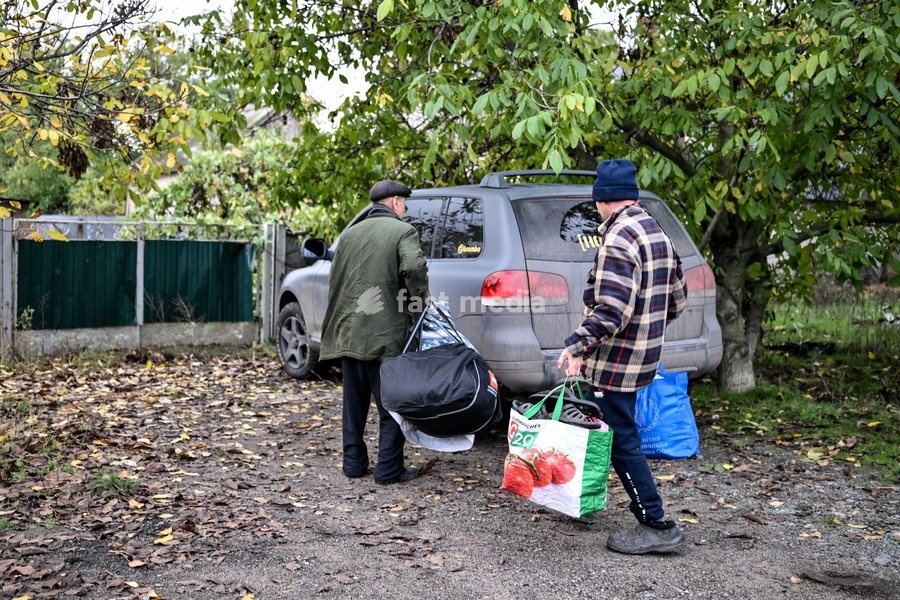 Local people load their personal belongings into a car during a humanitarian evacuation mission for their family from the front-line settlement of Komyshuvakha, Zaporizhzhia region, Ukraine, October 19, 2026