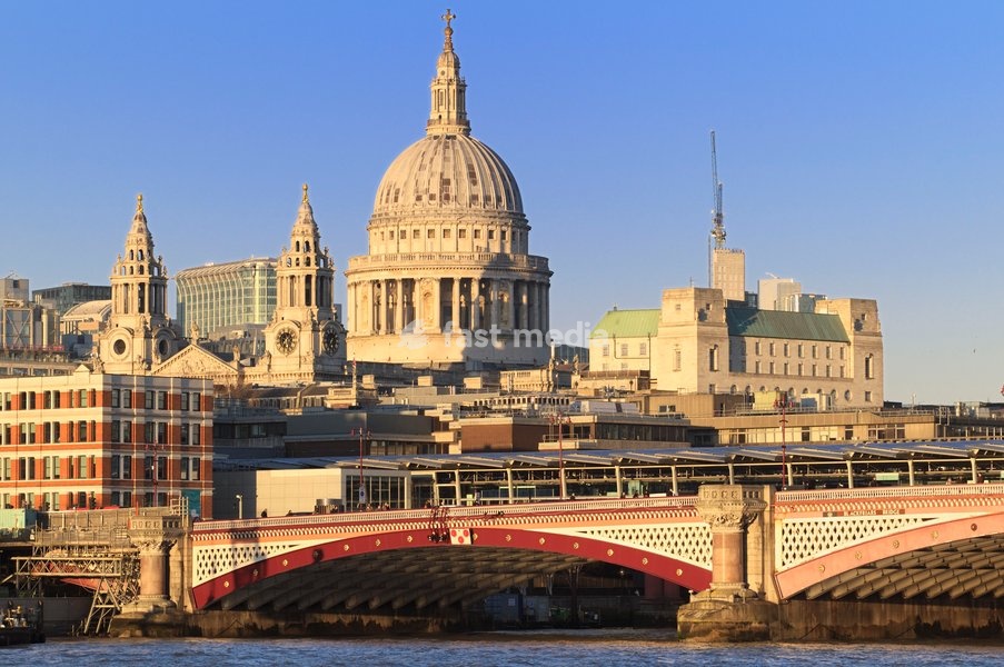 The famous St Paul's Cathedral dome with Blackfriars Bridge and station spanning the River Thames. View form South Bank. Architect: Sir Christopher Wren (1632-1723)