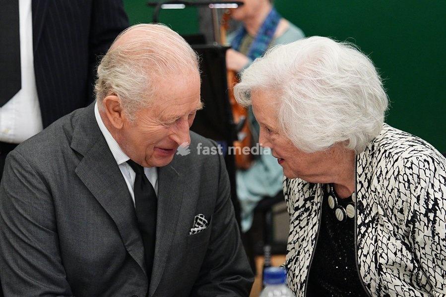 King Charles III speaks with Gloria Davies from the Aberfan Wives Group at Aberfan and Merthyr Vale Community Centre, during a visit to Aberfan to meet survivors, bereaved parents and members of the community and pay tribute to the 144 people who lost their lives in the Aberfan disaster on October…
