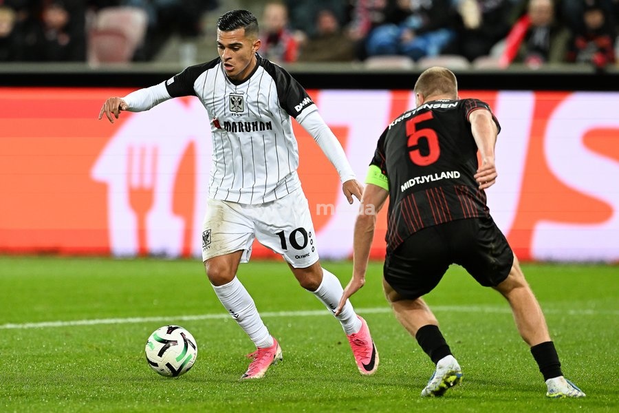 STVV's Ilias Sebaoui and Midtjylland's Rasmus Kristensen pictured in action during a soccer game between Danish FC Midtjylland and Belgian Sint-Truidense VV, Thursday 22 October 2026 in Herning, Denmark, on the second day of the UEFA Conference League league phase