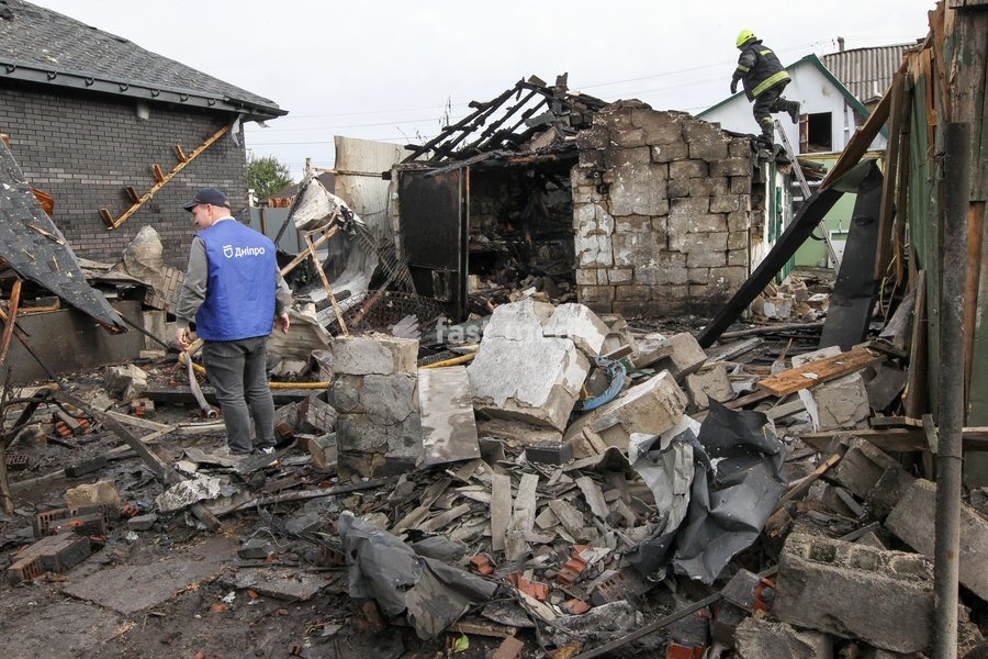 A man explores the ruins as rescuers work during a response effort to a Russian attack on a residential area in Dnipro, Ukraine, October 22, 2026. According to city head Borys Filatov, 11 private houses were damaged in the strike on Thursday morning, and one home burned down completely