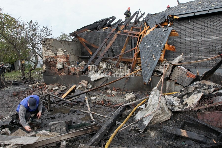 A man explores the ruins as rescuers work during a response effort to a Russian attack on a residential area in Dnipro, Ukraine, October 22, 2026. According to city head Borys Filatov, 11 private houses were damaged in the strike on Thursday morning, and one home burned down completely